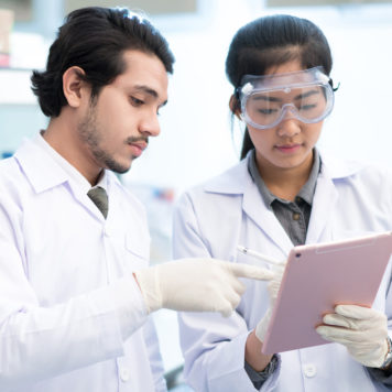 two scientists review data on tablet